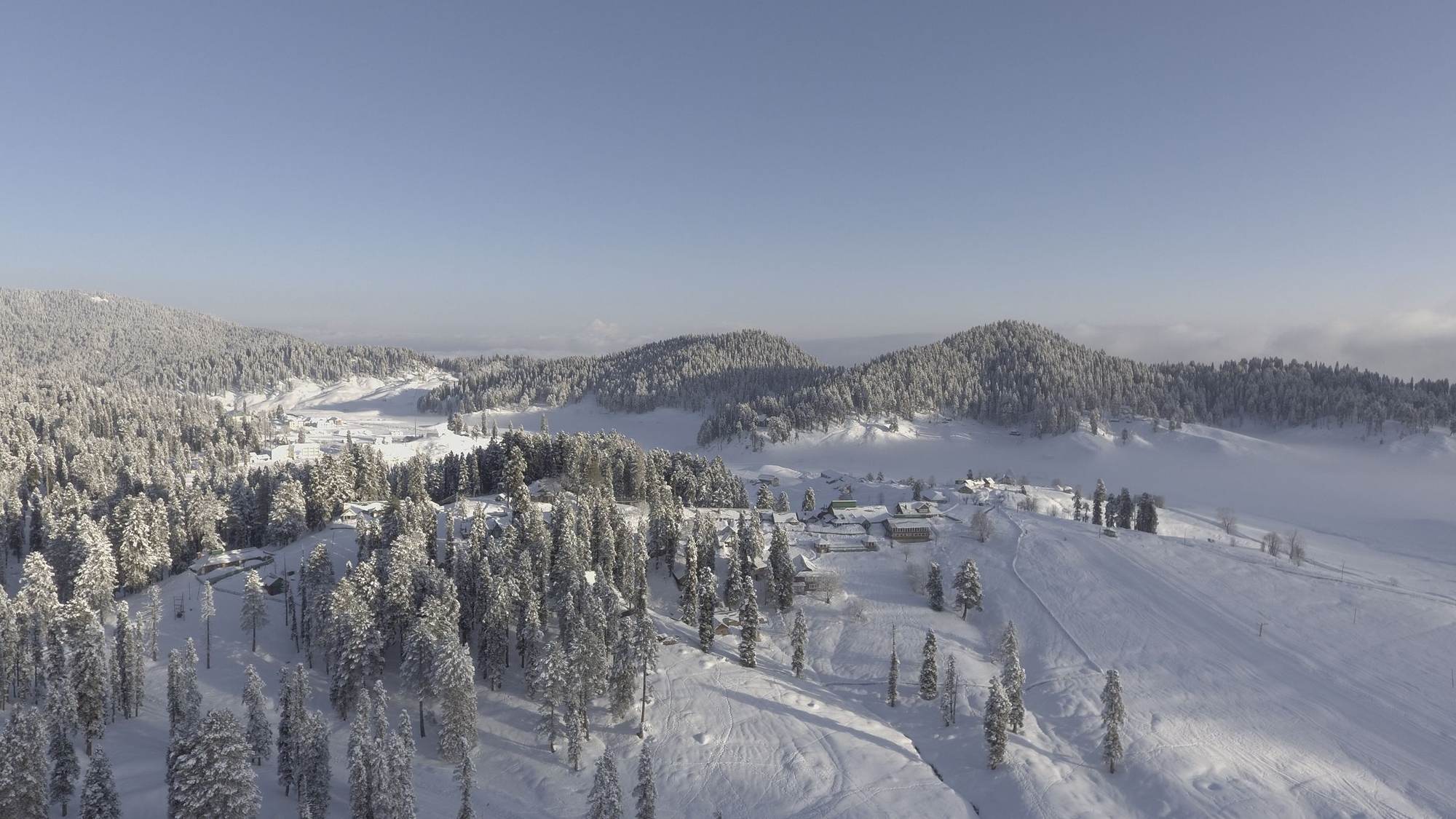 Aerial view of Gulmarg village and winter forest in the Pir Panjal
